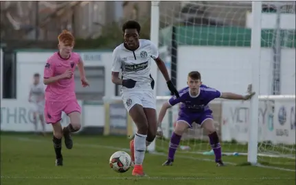  ??  ?? Destiny Idele of Bray Wanderers is closed down by Graham O’Reilly of Wexford F.C., with netminder Cian Browne alert at his near post.