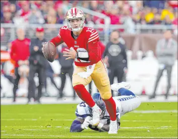  ?? Godofredo A. Vásquez
The Associated Press ?? 49ers QB Brock Purdy scrambles away from Seahawks defensive tackle Poona Ford in the wild-card round. Purdy’s four touchdowns sparked a 41-23 victory.