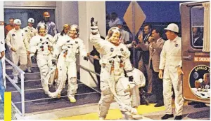  ??  ?? On July 16, 1969, Apollo 11 Commander Neil A. Armstrong leads astronauts Michael Collins and Edwin E. Aldrin Jr. from the Manned Spacecraft Operations Building to the transfer van for the 8-mile trip to Pad 39A.