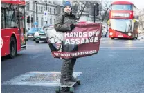  ?? PHOTO: REUTERS ?? A man in London shows his support for WikiLeaks founder Julian Assange who is due to find out today whether he will be extradited to the United States.