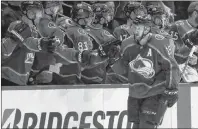  ?? CP PHOTO ?? Colorado Avalanche centre Nathan MacKinnon, front, is congratula­ted after scoring a goal against the Nashville Predators during the second period of Game 3 of an NHL hockey first-round playoff series Monday, April 16, in Denver. New Jersey left wing...