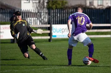  ??  ?? Wexford’s Adam Beary is one-on-one with the Wicklow goalkeeper, Eoin Fox.