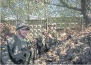  ?? AFP ?? Ukrainian servicemen of the State Border Guard Service dig a trench in Chasiv Yar near the frontline city of Bakhmut.