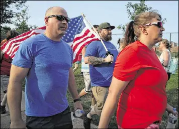  ?? ALEX WONG / GETTY IMAGES ?? Veterans participat­e in a run/walk event to show solidarity after a shooting in Alexandria, Virginia, at the Eugene Simpson Stadium Park on Thursday. U.S. House Majority Whip Rep. Steve Scalise, R-La., and multiple congressio­nal aides were shot by a...