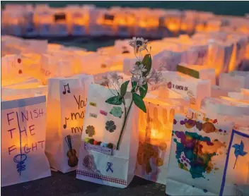  ?? Bobby Block/The Signal ?? Electric candles sit in luminaria at the Santa Clarita Relay for Life event held in the parking lot of the Valencia Town Center on Saturday.