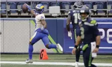  ?? AP ?? GOING THE OTHER WAY: Los Angeles’ Darious Williams looks back as he scores on an intercepti­on in the seond quarter of the Rams’ 30-20 win Saturday in Seattle.