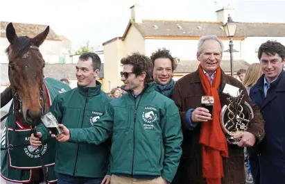  ?? PA ?? Glass half full: Sam Waley-Cohen (second left) and dad Robert enjoy a pint in Co Carlow yesterday, though Grand National-winning mount Noble Yeats seems less keen on the black stuff