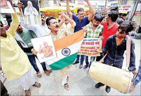  ?? GAGAN NAYAR/AFP ?? Members of right wing organisati­on ‘Sanskriti Bachao Manch’ celebrate in Bhopal on Monday after the Bharatiya Janata Party-led Indian government took steps to pull back the special status of Kashmir.