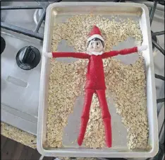  ??  ?? The Elf on the Shelf makes a snow angel in oatmeal.
