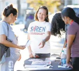  ?? JOSIE LEPE/STAFF ?? Alma Marroque, left, talks with Mayela Razo, center, Leonardo Cervantes, and Erica Leyva, right, members of SIREN, regarding voter registrati­on at Mi Pueblo in San Jose on Thursday.