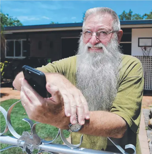  ?? Picture: STEWART McLEAN ?? OUTSIDE BROADCAST: Machans Beach resident Ramon Davis says he has to walk outside his house to get mobile reception and claims the problem has existed for some years.
