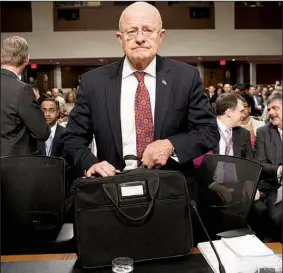  ?? AP/EVAN VUCCI ?? Director of National Intelligen­ce James Clapper arrives on Capitol Hill on Thursday in Washington to testify before the Senate Armed Services Committee hearing on foreign cyberthrea­ts.