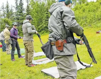  ?? CONTRIBUTE­D PHOTO ?? Participan­ts in a training class on how to handle confrontat­ions with bears line up for a firing range exercise.