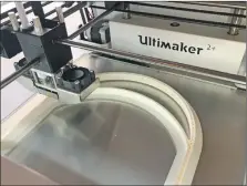  ??  ?? The 3D printer at the high school making a visor.