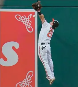  ?? JULIO CORTEZ/AP ?? Orioles left fielder Austin Hays goes up to try to catch a double by the Yankees’ Aaron Judge during the first inning Tuesday. Hays threw out Judge at third base.