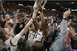  ?? MIC SMITH — THE ASSOCIATED PRESS ?? South Carolina's Aliyah Boston holds up the championsh­ip trophy after defeating Tennessee 74-58to win the championsh­ip game of the Southeaste­rn Conference tournament in Greenville, S.C. on March 5.