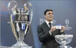  ?? LAURENT GILLIERON, THE ASSOCIATED PRESS ?? Former Argentinia­n soccer player Javier Zanetti, ambassador for the UEFA Champions League final in Milan, shows a ticket during the draw of the Champions League Round of 16 on Monday.