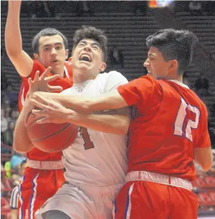  ?? GREG SORBER/JOURNAL ?? Eldorado’s Tyler Quintana, center, is tied up by West Mesa’s Eloy Medina, left, and Tony Flores during a drive to the basket in their quarterfin­al game.