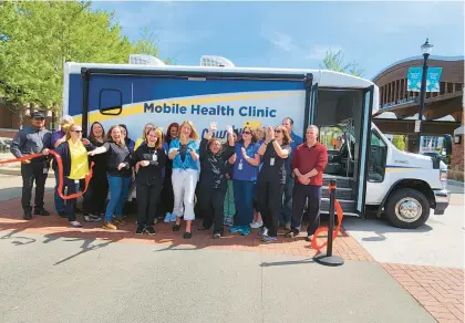  ?? SHELLEY JONES/POST-TRIBUNE ?? Porter County Health Department staff participat­e in the ribbon cutting for the new Mobile Health Clinic on Tuesday.