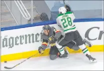  ?? Jason Franson The Associated Press ?? Golden Knights wing Ryan Reaves works his way through a check from Dallas Stars defenseman Stephen Johns (28) during the round robin of the Stanley Cup playoffs.
The Knights are battling for top seed in the West.