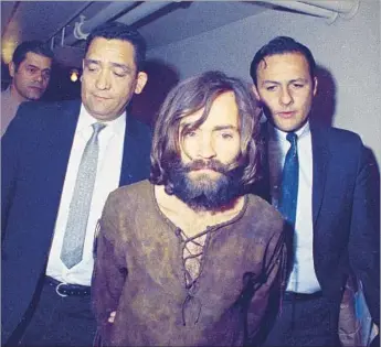 ?? Associated Press ?? INFAMOUS CRIMINAL Charles Manson is escorted to his arraignmen­t on conspiracy-murder charges in connection with the killing of actress Sharon Tate in Los Angeles in 1969.