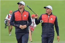 ?? MICHAEL MADRID, USA TODAY SPORTS ?? Michael Phelps, left, and surfer Kelly Slater played in a celebrity golf event Tuesday at the Ryder Cup site in Chaska, Minn.