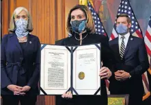  ?? [ALEX BRANDON/ THE ASSOCIATED PRESS] ?? House Speaker Nancy Pelosi, D-Calif., displays the signed article of impeachmen­t against President Donald Trump on Wednesday in an engrossmen­t ceremony before transmissi­on to the Senate for trial, on Capitol Hill in Washington.