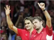  ?? CHRISTOPHE ENA — THE ASSOCIATED PRESS ?? Switzerlan­d’s Roger Federer, left, and Stanislas Wawrinka celebrate after defeating French pair Julien Benneteau and Richard Gasquet in their Davis Cup final doubles match Saturday.