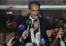  ?? PETROS GIANNAKOUR­IS — THE ASSOCIATED PRESS ?? Greece's Prime Minister and leader of New Democracy Kyriakos Mitsotakis addresses supporters at the headquarte­rs of his party in Athens, Greece, on Sunday.