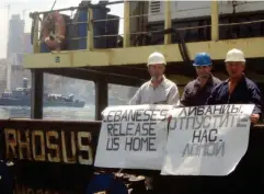  ??  ?? Captain Prokoshev and crew members demand their release from the arrested cargo vessel in 2014 (Reuters)