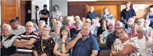  ?? PHOTO: GREGOR RICHARDSON ?? Fronting . . . Middlemarc­h residents listen at a meeting with Dunedin City and Otago Regional Council staff about serious flooding last month.