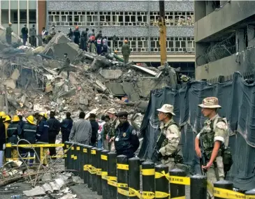  ??  ?? BAD OUTCOME After attacks on two U.S. embassies in Africa in 1998 (here, rescue workers search the rubble), missile strikes against Al-qaeda in Afghanista­n and Sudan missed their targets.