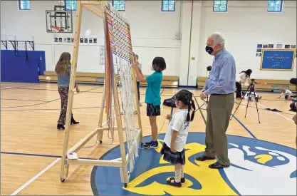  ?? Contribute­d photos / Whitby School ?? Above and below, students at Whitby School in Greenwich work on a social distance-inspired weaving project.