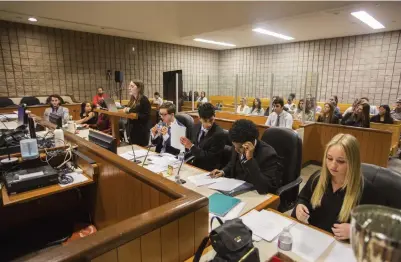  ?? JULIE JOCSAK ST. CATHARINES STANDARD ?? Students from A.N. Myer Secondary School and Denis Morris High School faced off in the final case during a mock trial at the St. Catharines courthouse on Friday. Each team was mentored by a local lawyer or Crown attorney.