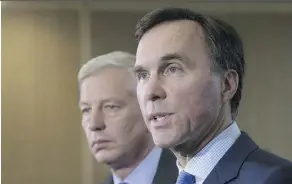  ?? ADRIAN WYLD/THE CANADIAN PRESS ?? Chairman of the Advisory Council Dominic Barton, left, and Finance Minister Bill Morneau respond to reporters’ questions on the council’s growth stimulatio­n ideas, Thursday.