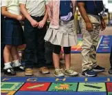  ??  ?? Top: Perla Elizondo, right, talks to her kindergart­en class at Spanish Schoolhous­e Preschool in Kingwood. Above: Day care operators say that unless enrollment levels increase quickly, they may have to close the doors.