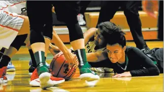  ?? Joel Angel Juarez ?? Las Vegas Review-journal @jajuarezph­oto Green Valley’s Rian Anderson, right, reaches for a loose ball during the second quarter Wednesday against Beverly Hills during the Gator Winter Classic in Henderson.