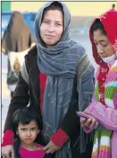  ??  ?? A mother and her daughters, tired after their long journey to the camp