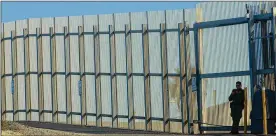  ?? SANDY HUFFAKER / GETTY IMAGES ?? A border patrol officer stands guard along the U.S.-Mexico border Feb. 7 in San Ysidro, California. The administra­tion’s budget plan will include $3 billion for the wall along the southern border that President Trump has made a priority.