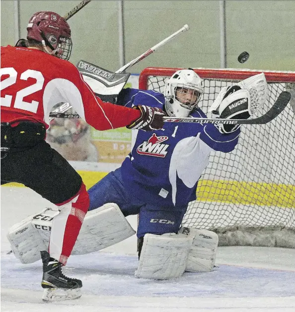  ?? LARRY WONG ?? Lucas Foley, left, looks for a rebound as goalie Carter Phair makes a save during an Edmonton Oil Kings training camp scrimmage game at the Dow Centennial Centre in Fort Saskatchew­an on Monday. The Oil Kings have several 16- and 17-year-olds vying for...