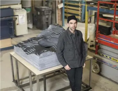  ?? RANDY RISLING/TORONTO STAR ?? Alex Mustonen, partner and co-founder of New York design agency Snarkitect­ure, with the 37-layer Caesarston­e top of “Ice” island, one of four concept kitchen islands to debut at the Interior Design Show.