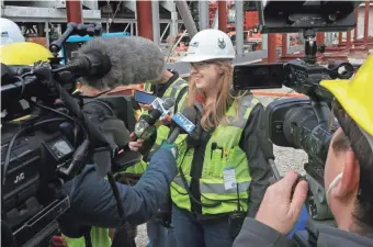  ?? MIKE DE SISTI / MILWAUKEE JOURNAL SENTINEL ?? Ellen Becker, a project engineer with Mortenson Constructi­on, the constructi­on manager for the new Bucks arena project, talks to the media last week when the first roof truss was being raised. For more photos and video of the constructi­on, go to...