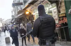  ?? Heidi Levine for The National ?? Israeli security patrol the Old City of Jerusalem yesterday ahead of Donald Trump’s announceme­nt