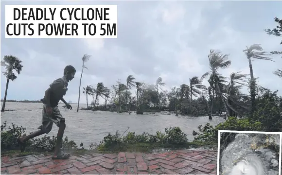  ??  ?? A boy awaits the landfall of Cyclone Amphan (inset), in Dacope, Bangladesh. Picture: Munir Uz Zaman/AFP