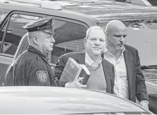  ?? Andres Kudacki / Associated Press ?? Harvey Weinstein arrives at the first precinct police station in New York on Friday to turn himself in to authoritie­s following allegation­s of rape and criminal sex acts.