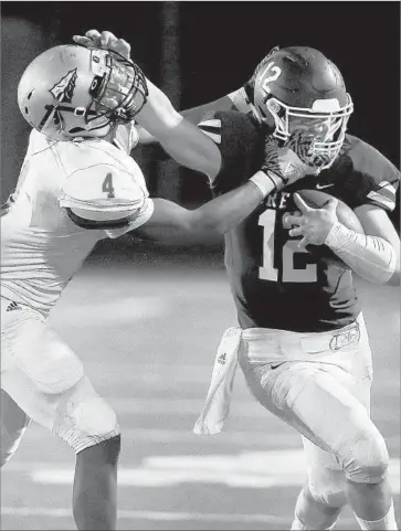  ?? Rick Loomis Los Angeles Times ?? ALEMANY’S Elyjah Doyle grabs the facemask of Crespi’s Hamish McClure as he tries to make the tackle.