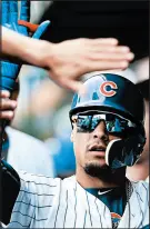  ?? JOHN J. KIM/CHICAGO TRIBUNE ?? The Cubs’ Javier Baez is congratula­ted after scoring in the seventh inning Saturday in Game 1.