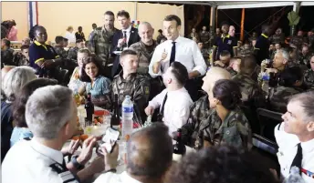  ??  ?? Macron speaks to the troops as he attends a Christmas dinner with French soldiers at the PortBouet military camp near Abidjan on the first day of his three day visit to test Africa. — AFP photo