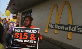  ??  ?? People gather at a McDonald’s restaurant in Miami to demand a minimum wage increase to $15 an hour. Photograph: Joe Raedle/Getty Images