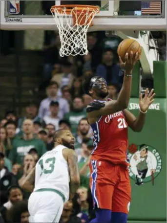  ?? ELISE AMENDOLA — THE ASSOCIATED PRESS ?? Sixers center Joel Embiid, right, gets a step on Boston Celtics forward and Philadelph­ia native Marcus Morris en route to an easy layup Monday night in the opener of the Eastern Conference semifinal series between the teams. But it was mostly Embiid...